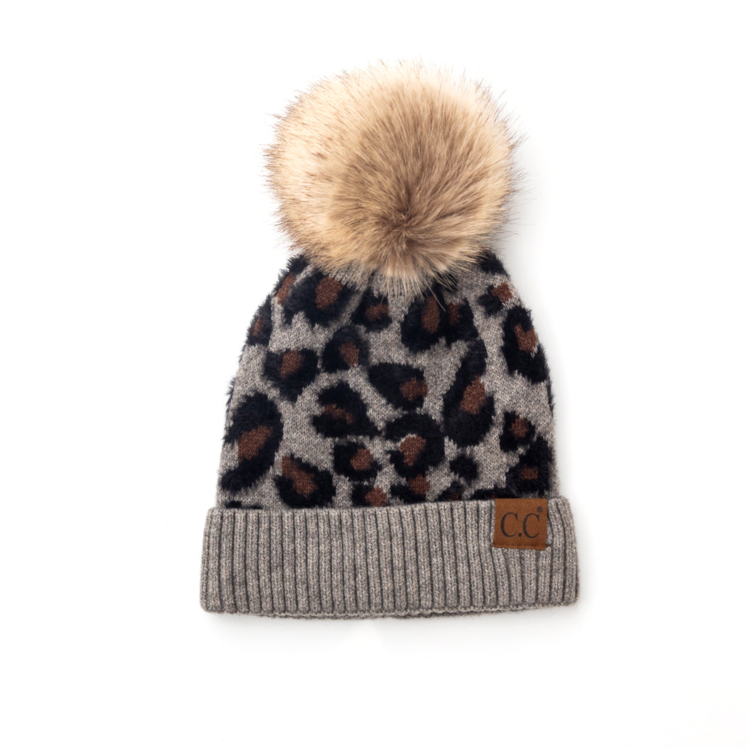 Grey and black leopard-print pom beanie on a white background.