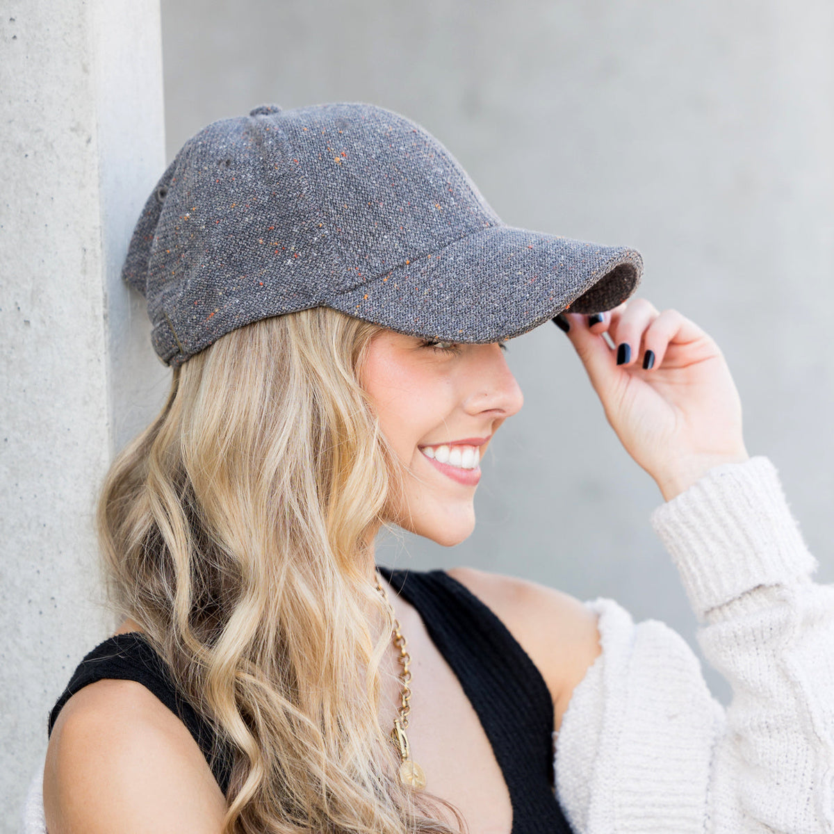 Grey tweed-style baseball cap shown from the side.