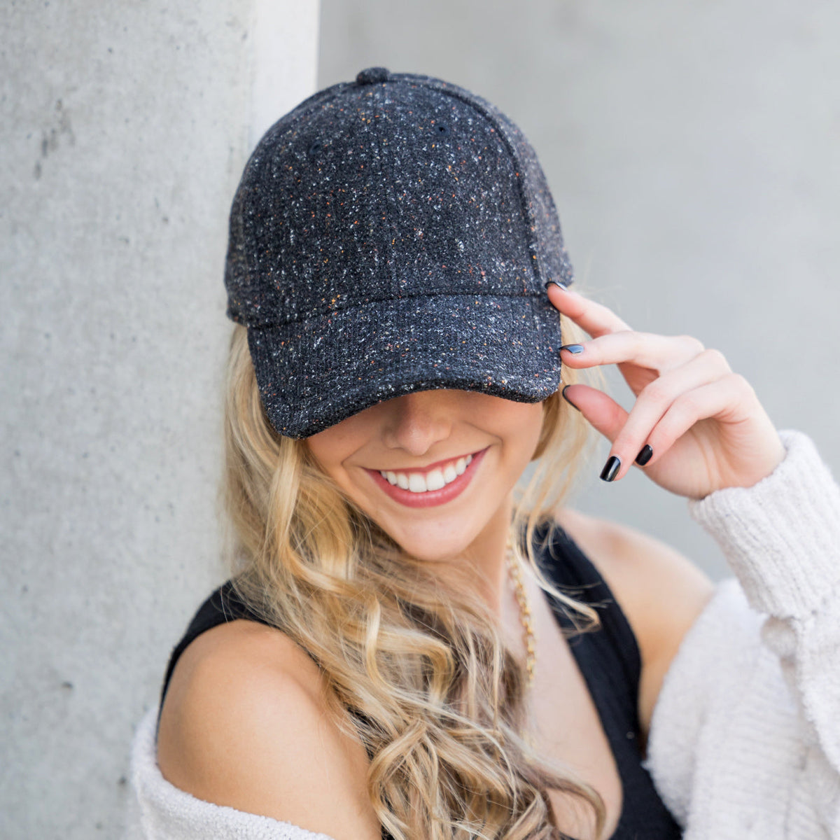 Navy tweed-style baseball cap shown from the front.
