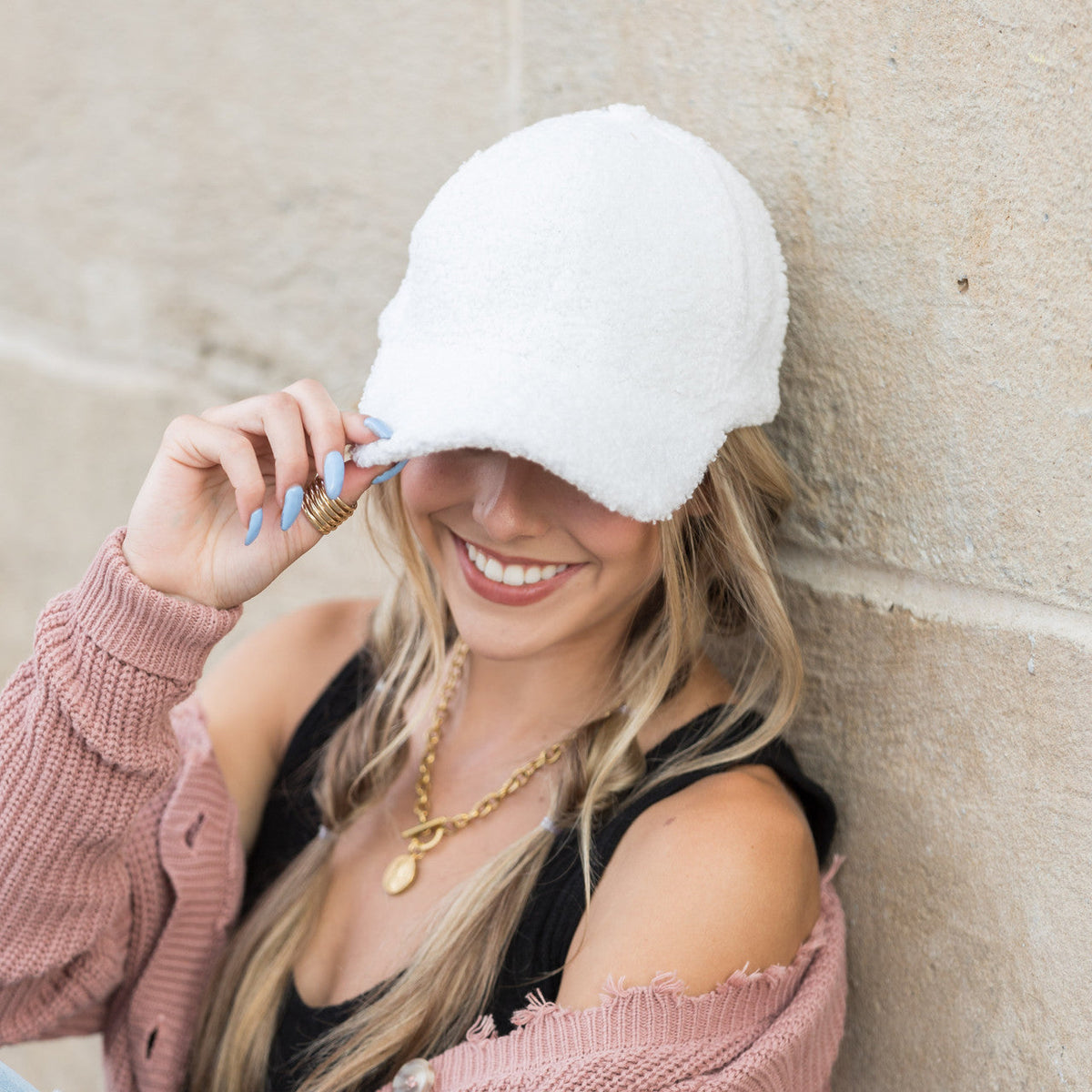 White textured baseball cap worn on a model.