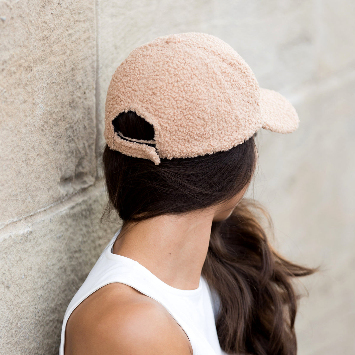 Rear view of a light camel textured baseball cap showing its adjustable closure.