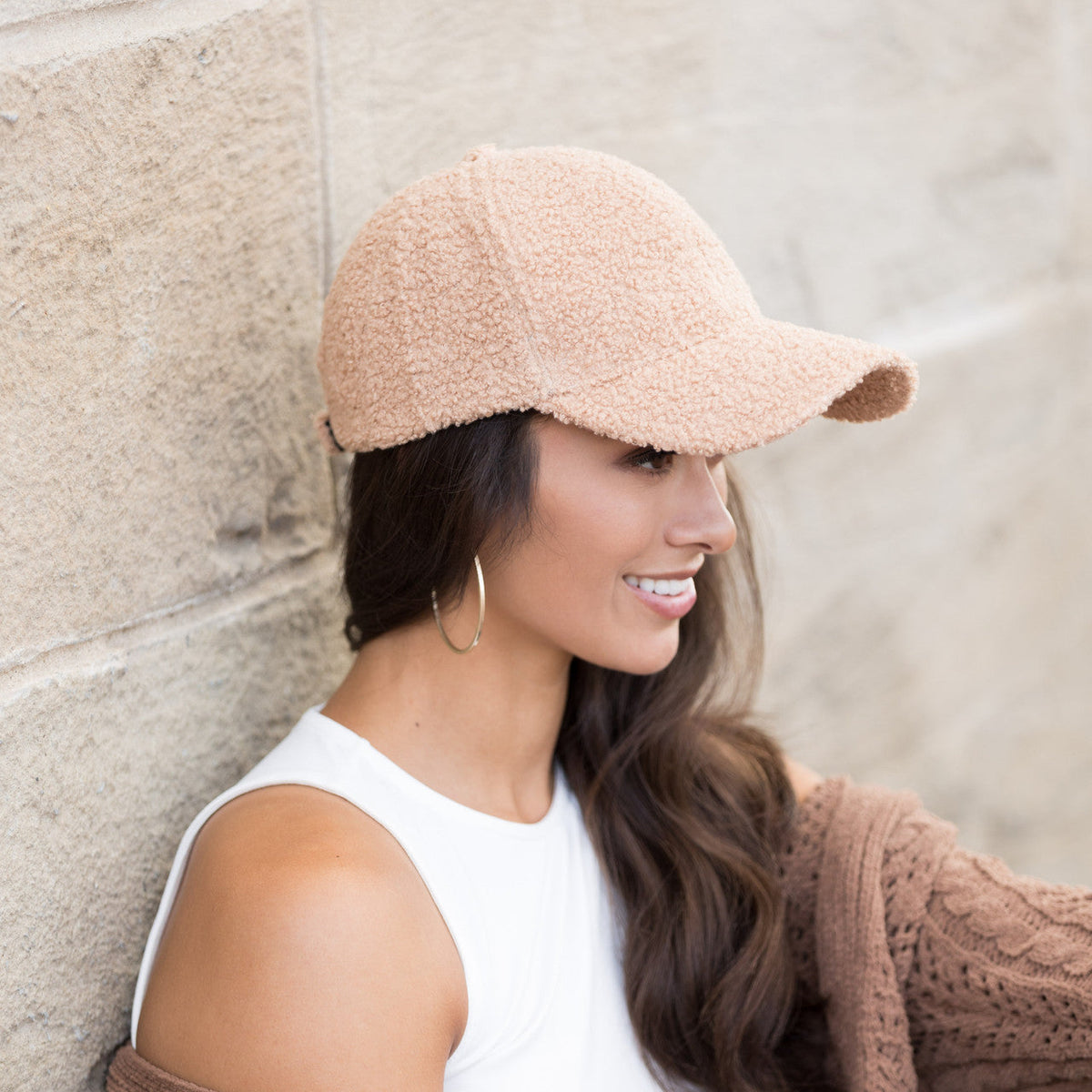 Light camel textured baseball cap worn on a model.