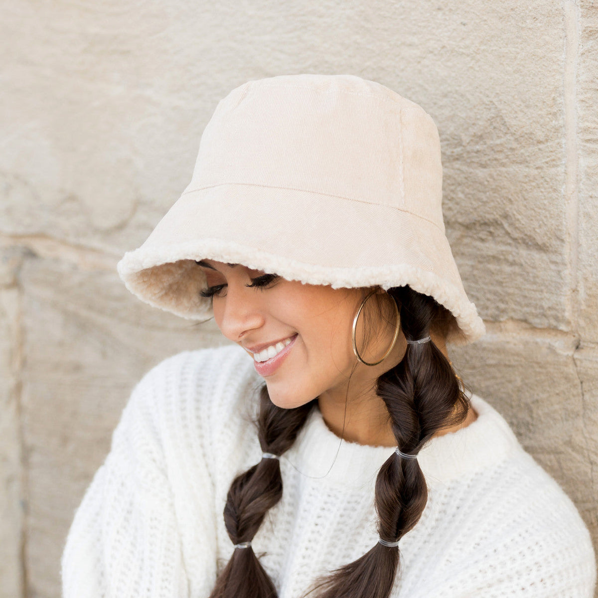 Cream textured reversible bucket hat shown from the side.