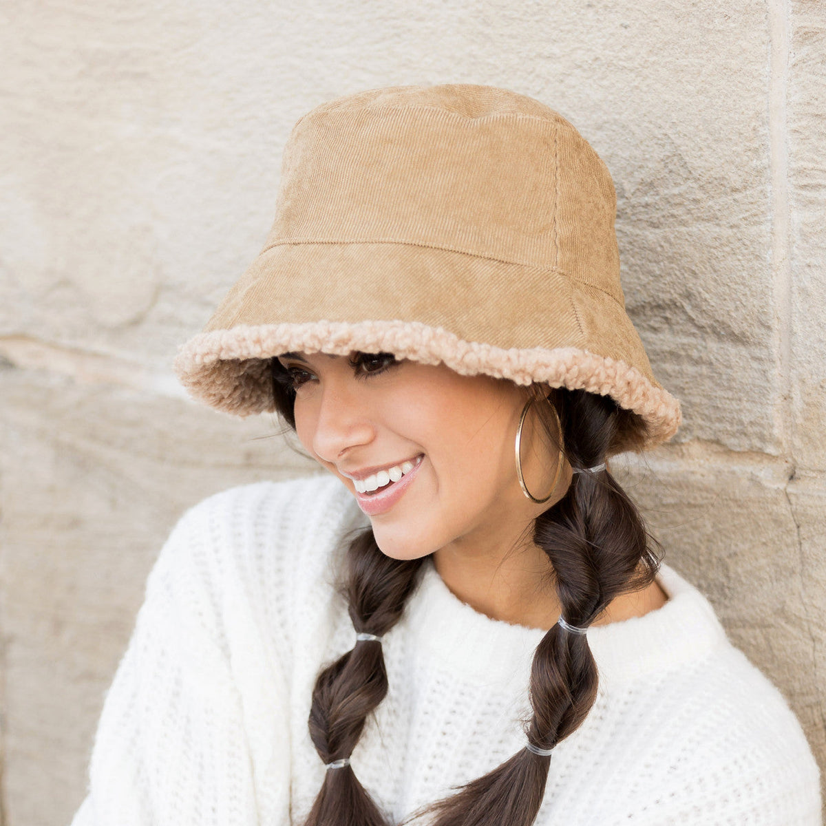 Khaki textured reversible bucket hat shown from the side.