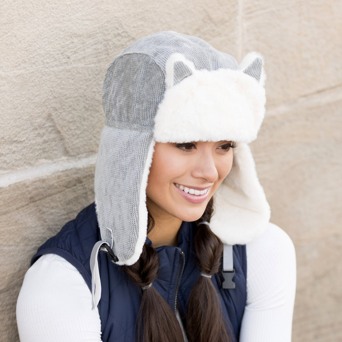 Side view of a grey kitten-ear trapper hat.