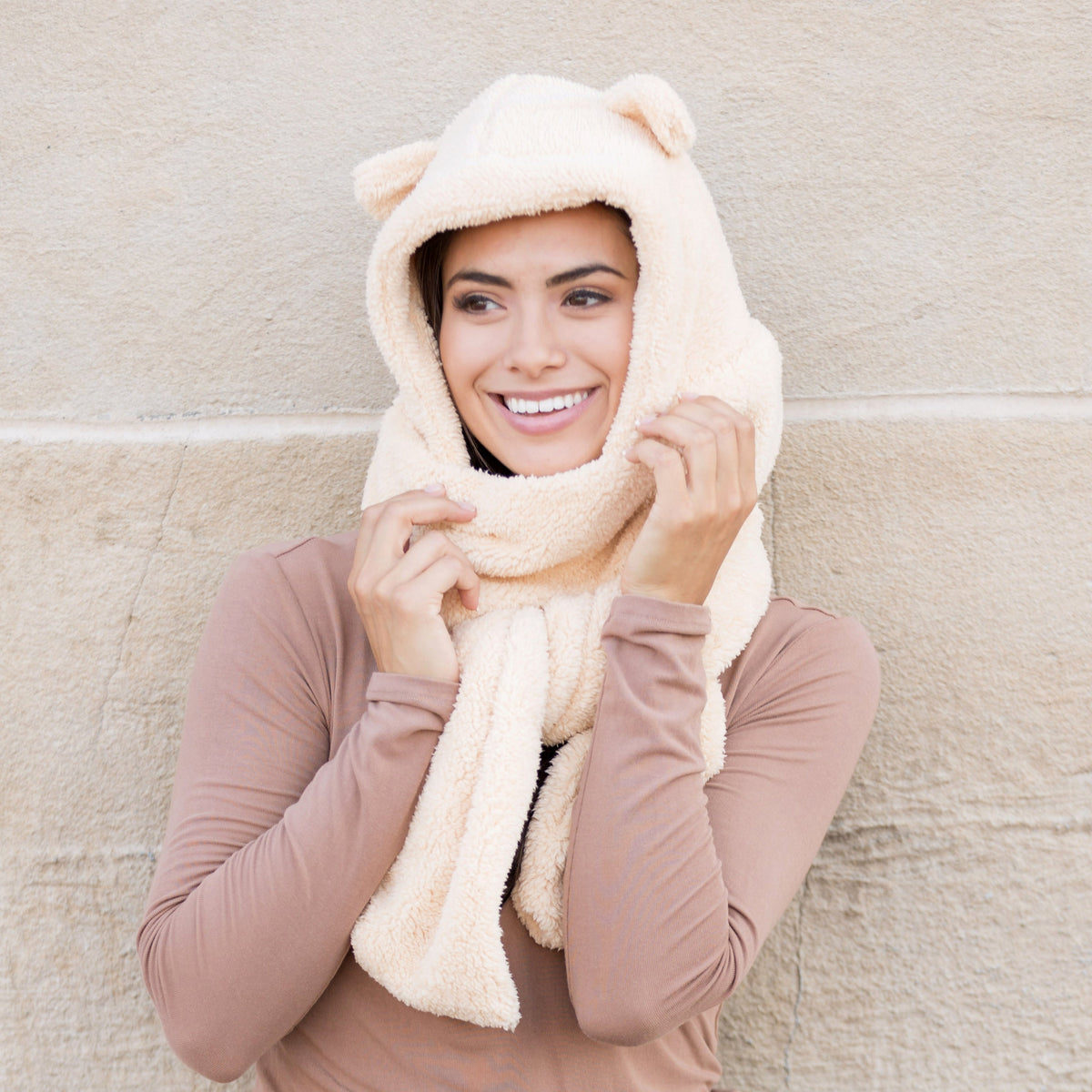 Almond-colored bear-ear hooded scarf worn with the scarf ends held in front.