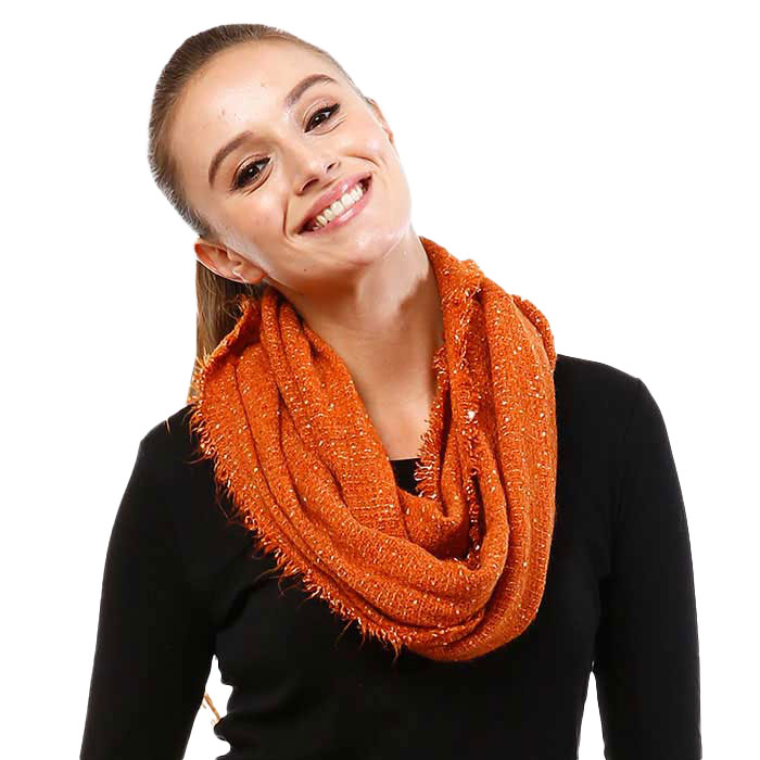 Coral boucle infinity scarf worn with a black top.