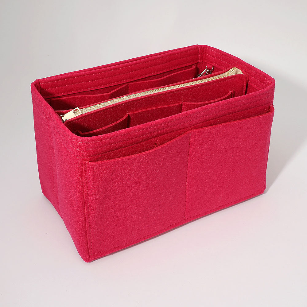Fuchsia handbag organizer insert with front pockets and a zippered compartment.