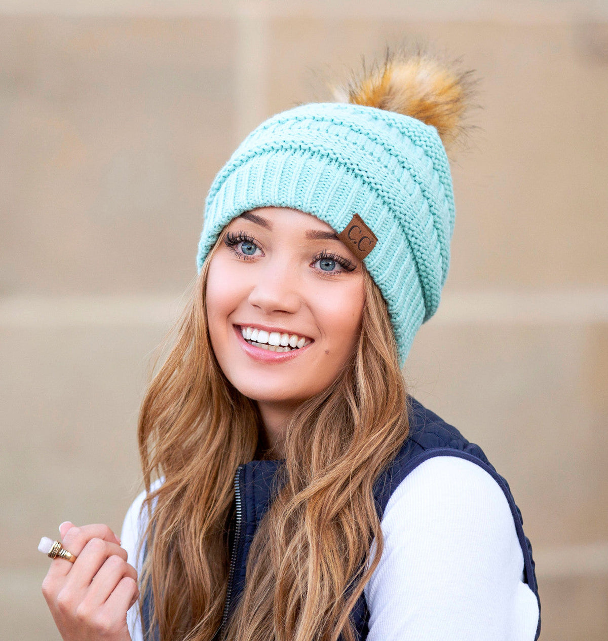 Mint textured knit pom beanie worn on a model.