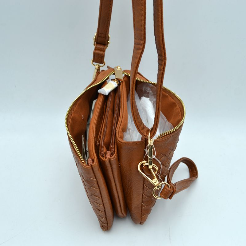 Brown woven wristlet clutch open to show interior compartments