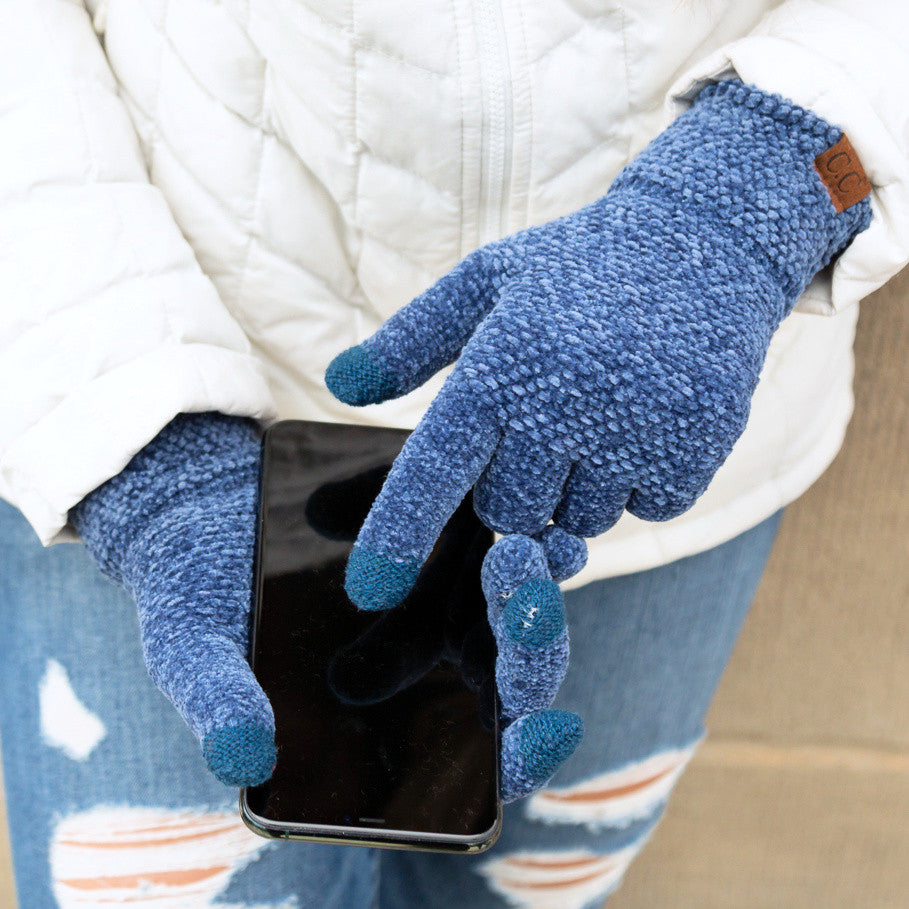 Dark blue textured gloves shown with a black phone.