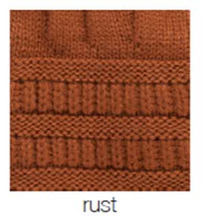 Close-up of rust-colored cable-knit fabric.