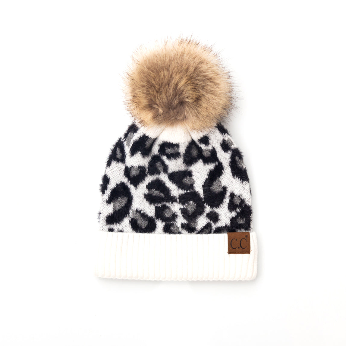 White and black leopard-print pom beanie on a white background.