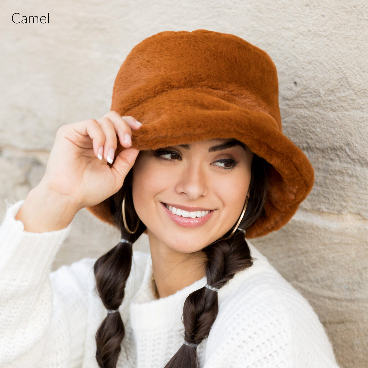 Camel-colored plush bucket hat shown from the front.
