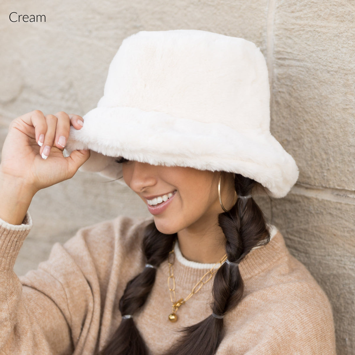 Cream plush bucket hat shown from the side.
