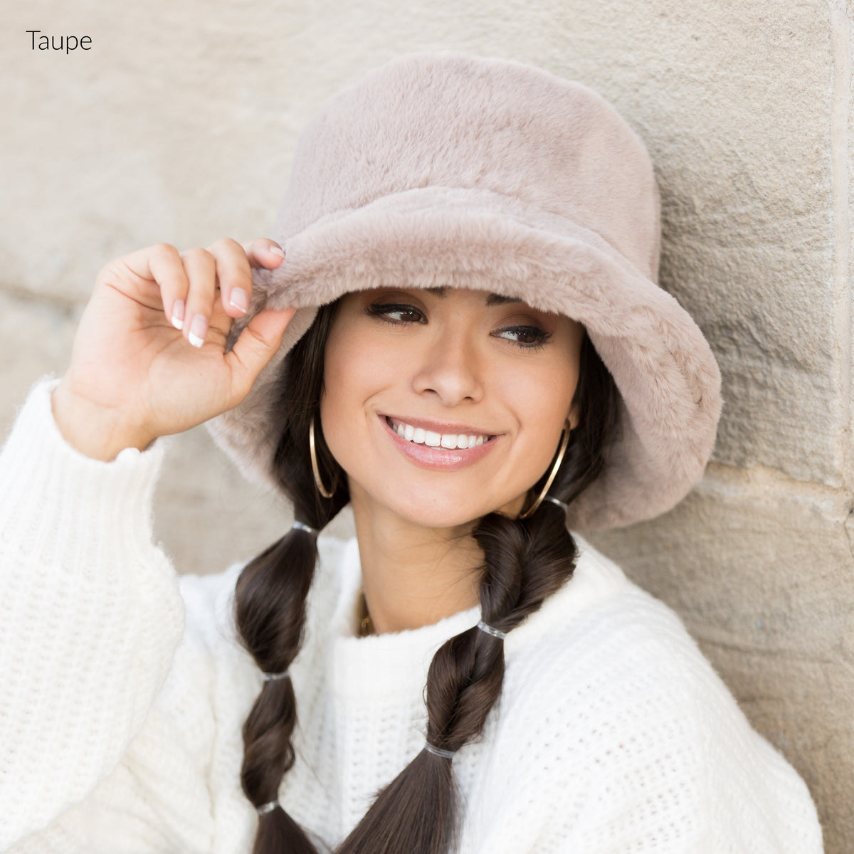 Taupe plush bucket hat shown from the front.
