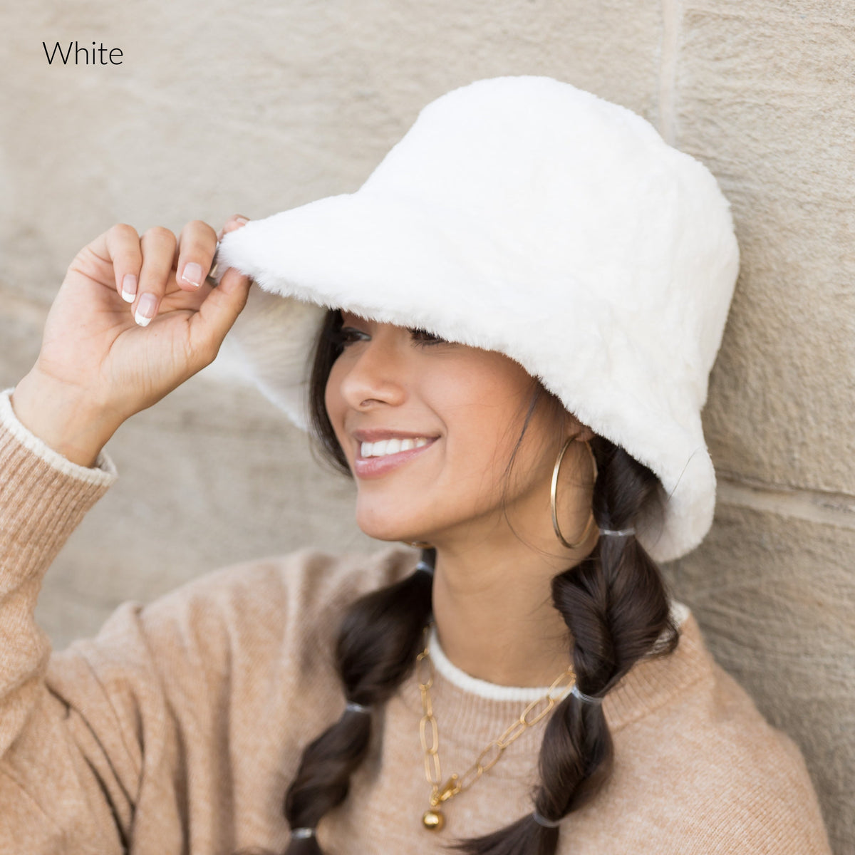 White plush bucket hat shown from the side.