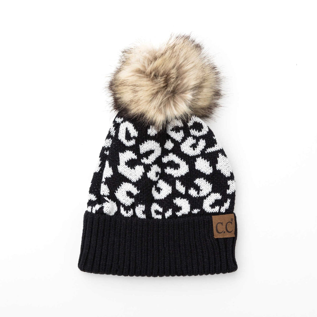Black and white leopard-pattern beanie with a brown pom on a white background.