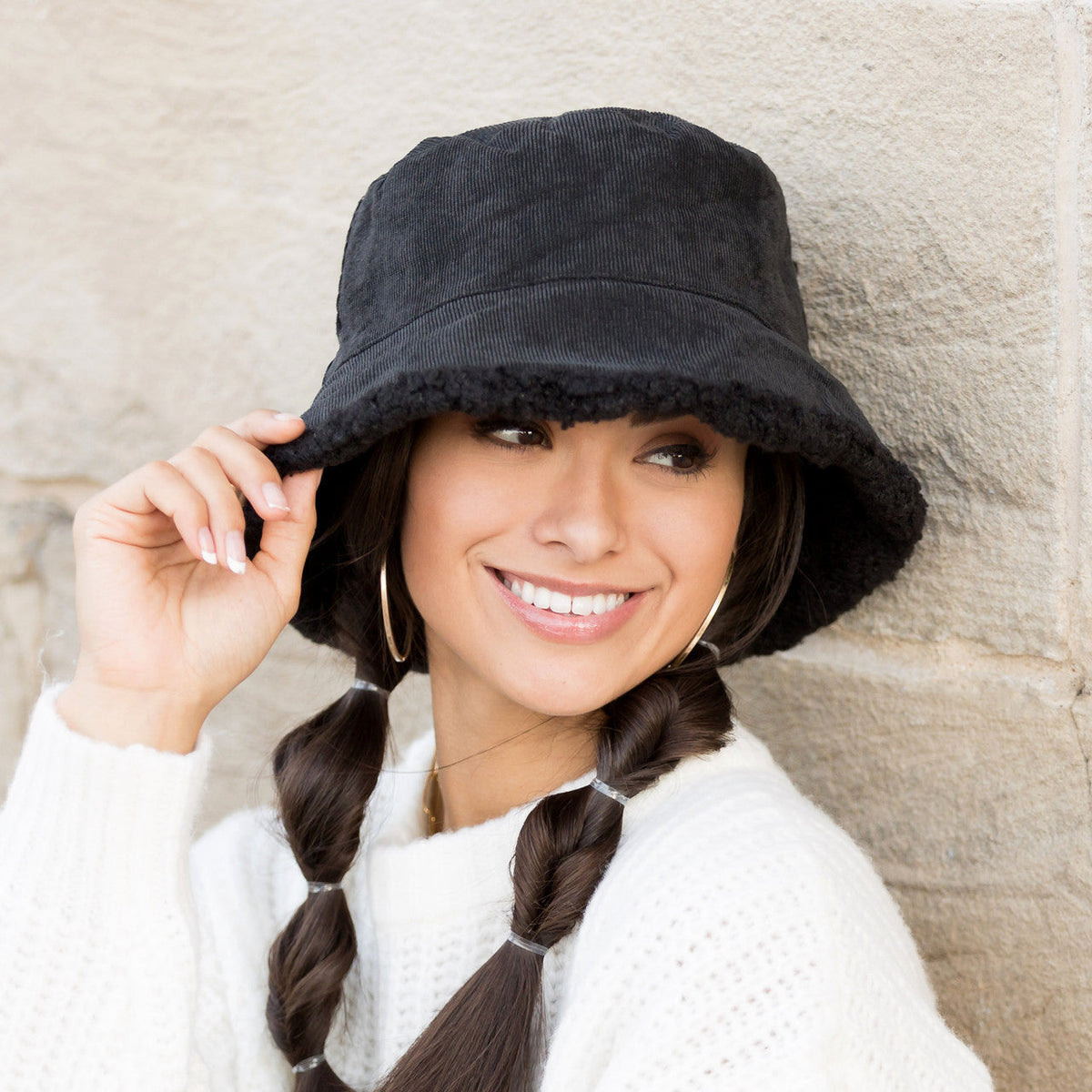 Black textured reversible bucket hat worn on a model.