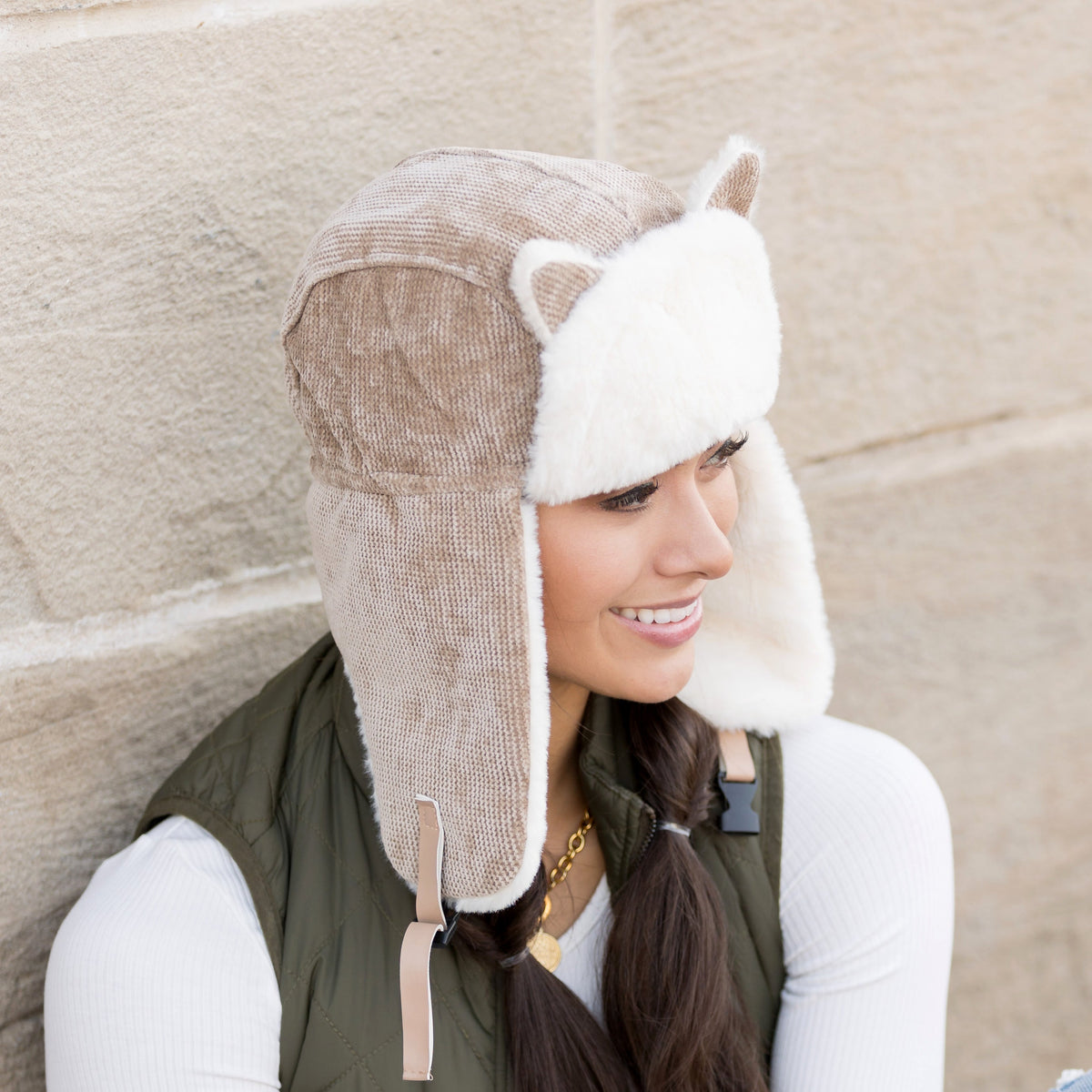 Taupe kitten-ear trapper hat shown from the side.