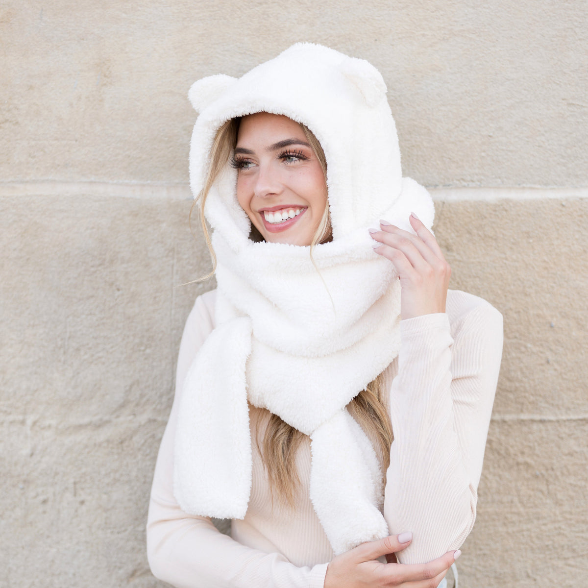 Cream plush hooded scarf shown with its long scarf ends.