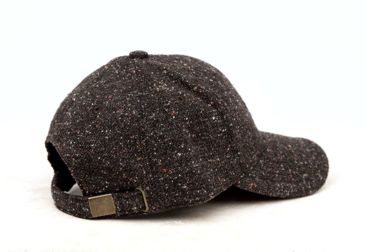 Black tweed-style baseball cap shown from the side on a white background.