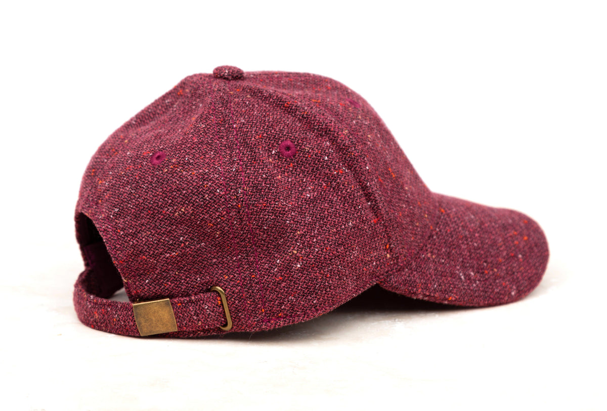 Burgundy tweed-style baseball cap shown from the side on a white background.