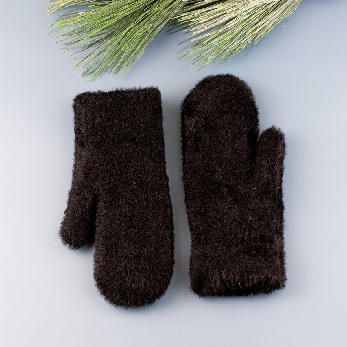 Black plush mittens displayed on a blue background.