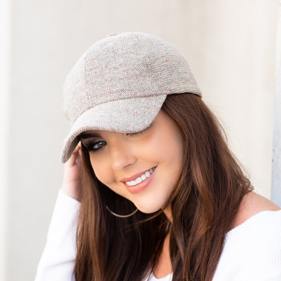 Light grey tweed-style baseball cap worn on a model.