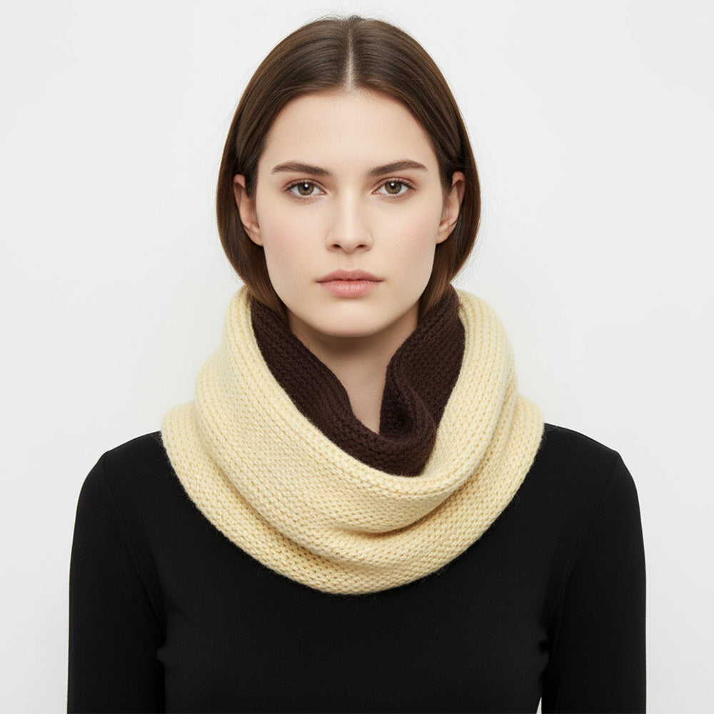 Beige and brown two-tone chunky knit infinity scarf worn with a black top.